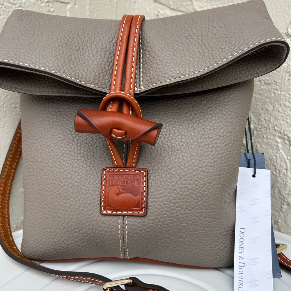 Dooney & Bourke Pebble Grain Toggle Crossbody bag in a gray color With Brown